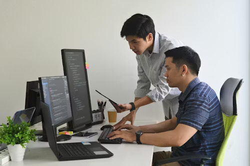 Developer pair-programming at a laptop